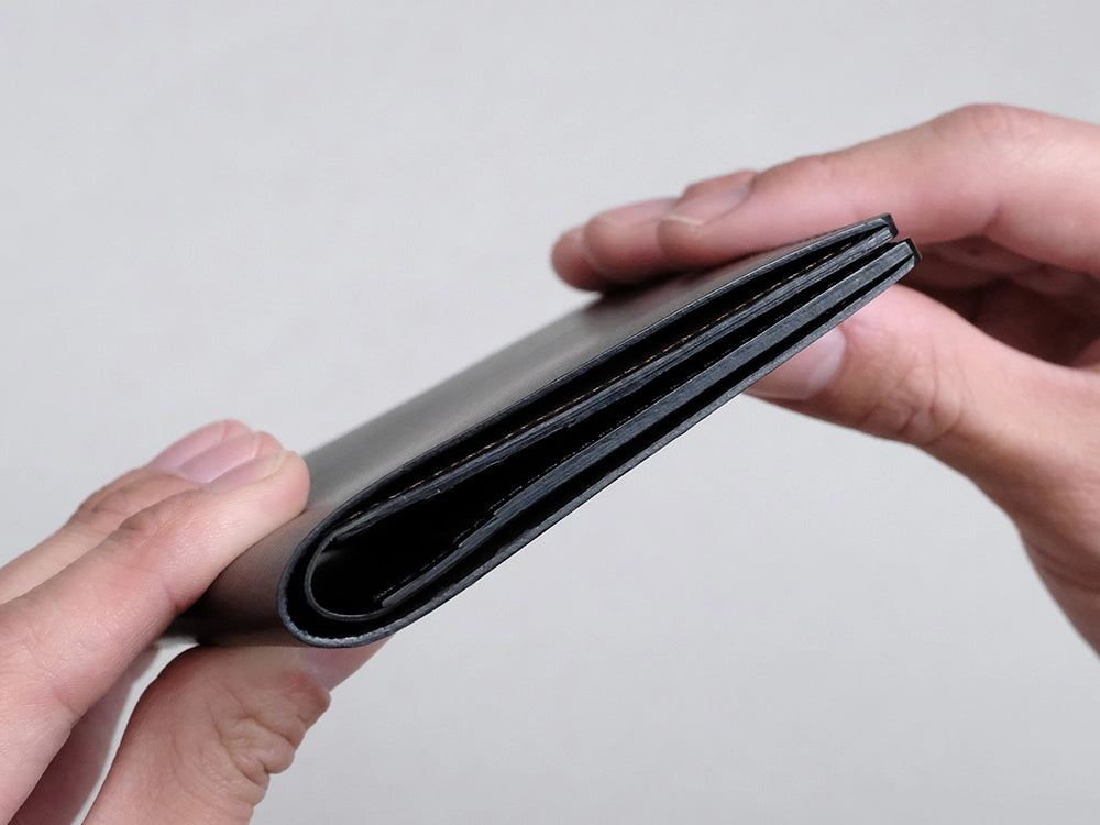 最大容量（お札約25枚・カード7枚）を収納した場合でも、厚みは約2.1cmに収まります。すっきりとしたフォルムを保ちながらお使いいただけます。